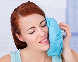 Woman icing her cheek