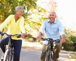 Senior couple riding bikes at park
