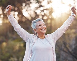 a dentures patient smiling and cheering