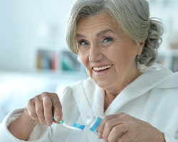 Dentures patient in Houston brushing their teeth