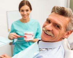 Dentures patient in Houston talking to dentist