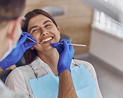 Woman smiling at dentist during exam